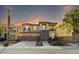 Inviting two-story home featuring a stone facade, a well-manicured front yard, and a spacious two car garage at 7017 Pink Flamingos Pl, North Las Vegas, NV 89084