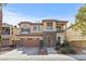 Charming two-story home featuring a stone facade, a well-manicured front yard, and a two car garage at 7017 Pink Flamingos Pl, North Las Vegas, NV 89084