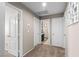 Hallway with carpet floors, white doors, and art on the wall at 7017 Pink Flamingos Pl, North Las Vegas, NV 89084