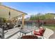 Relaxing outdoor patio area with comfortable seating and a view of the pool at 7017 Pink Flamingos Pl, North Las Vegas, NV 89084