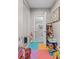 Organized playroom area with an open door, filled with toys and leading to a convenient bathroom at 7017 Pink Flamingos Pl, North Las Vegas, NV 89084