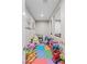 Bright playroom area adorned with colorful mats and various toys, creating a playful and engaging space at 7017 Pink Flamingos Pl, North Las Vegas, NV 89084