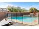 Fenced pool with a spa and lounge chairs, perfect for outdoor relaxation at 7017 Pink Flamingos Pl, North Las Vegas, NV 89084