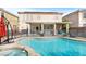 A backyard oasis featuring a refreshing pool, relaxing hot tub, and covered patio perfect for entertaining at 7017 Pink Flamingos Pl, North Las Vegas, NV 89084