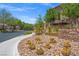 Community entrance sign surrounded by desert landscaping, including cacti and succulents at 7171 Willow Moss Ct, Las Vegas, NV 89148