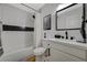 Well-lit bathroom features a shower-tub combo, modern vanity with black hardware, and sleek fixtures at 7285 Pinebrook Cir, Las Vegas, NV 89147