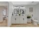 Bathroom featuring double sinks, white cabinetry, and modern fixtures at 7285 Pinebrook Cir, Las Vegas, NV 89147