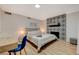 Comfortable bedroom featuring decorative fireplace, desk, wood-look flooring, and a plush bed at 7285 Pinebrook Cir, Las Vegas, NV 89147