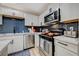 Well-equipped kitchen with stainless steel appliances, modern cabinets, and stylish backsplash at 7285 Pinebrook Cir, Las Vegas, NV 89147