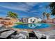 Backyard pool area with lounge seating, patio table, and well-maintained backyard and landscaping at 7285 Pinebrook Cir, Las Vegas, NV 89147