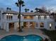 Luxury home with a pool, patio, balcony, and lush landscaping, offering a private outdoor retreat at 74 Innisbrook Ave, Las Vegas, NV 89113
