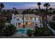 Expansive home with a pool, manicured landscaping, and outdoor living spaces, offering a luxurious retreat at 74 Innisbrook Ave, Las Vegas, NV 89113