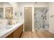 Elegant bathroom featuring marble countertops, dual sinks, and a sleek glass-enclosed shower at 74 Innisbrook Ave, Las Vegas, NV 89113