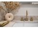 Close-up of a sink with elegant gold fixtures and decorative accents in a modern bathroom at 74 Innisbrook Ave, Las Vegas, NV 89113
