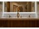 Modern bathroom with dual sinks, marble countertops, and wood cabinets at 74 Innisbrook Ave, Las Vegas, NV 89113