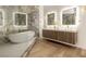 A luxury bathroom with a freestanding tub, marble accents, and a modern vanity at 74 Innisbrook Ave, Las Vegas, NV 89113