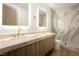 Luxurious bathroom featuring dual sinks, a marble countertop, and a glass-enclosed shower at 74 Innisbrook Ave, Las Vegas, NV 89113