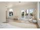 Bright bedroom with balcony access, arched window, and herringbone wood floors at 74 Innisbrook Ave, Las Vegas, NV 89113