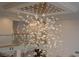Elegant chandelier featuring intricate designs and a mirrored ceiling creating a sophisticated and modern aesthetic at 74 Innisbrook Ave, Las Vegas, NV 89113