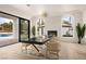 Open dining room with indoor fireplace and large glass doors offering a pool view at 74 Innisbrook Ave, Las Vegas, NV 89113