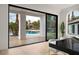 Dining area featuring a view of the pool, an open sliding glass door, and bright walls at 74 Innisbrook Ave, Las Vegas, NV 89113