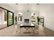 Bright dining room with modern decor, light walls, herringbone wood flooring, and a fireplace feature at 74 Innisbrook Ave, Las Vegas, NV 89113