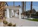 Wide driveway with elegant landscaping and palm trees lining the front, adding to the home's curb appeal at 74 Innisbrook Ave, Las Vegas, NV 89113