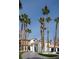 Striking front view of a home with tall palm trees, creating a tropical ambiance and architectural charm at 74 Innisbrook Ave, Las Vegas, NV 89113