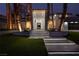 Inviting home entrance with illuminated steps, manicured lawn, and towering palm trees, creating a luxurious curb appeal at 74 Innisbrook Ave, Las Vegas, NV 89113