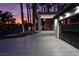 Spacious driveway leading to a modern garage with glass panel doors, complemented by manicured landscaping and elegant lighting at 74 Innisbrook Ave, Las Vegas, NV 89113