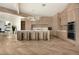 Modern kitchen with wooden cabinets, marble countertops, stylish island seating, and stainless steel appliances at 74 Innisbrook Ave, Las Vegas, NV 89113