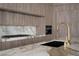 Spacious kitchen featuring marble countertops, a modern faucet, custom cabinets, and a built-in coffee maker at 74 Innisbrook Ave, Las Vegas, NV 89113