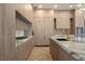 Contemporary kitchen featuring stylish wood cabinetry, marble countertops, a gas cooktop, and stainless steel appliances at 74 Innisbrook Ave, Las Vegas, NV 89113