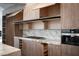 Open kitchen with custom cabinetry, marble backsplash, modern appliances, and stylish hardware at 74 Innisbrook Ave, Las Vegas, NV 89113