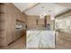 Elegant kitchen featuring custom wood cabinetry, marble countertops, brass fixtures, and a view of the grand piano at 74 Innisbrook Ave, Las Vegas, NV 89113