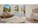 Bright main bedroom features hardwood floors, arched windows, and backyard views at 74 Innisbrook Ave, Las Vegas, NV 89113