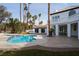 Beautiful backyard oasis featuring a sparkling pool, patio, and lush landscaping at 74 Innisbrook Ave, Las Vegas, NV 89113