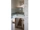 Modern staircase with glass railings, open design, and unique chandelier creating an airy and stylish transition between floors at 74 Innisbrook Ave, Las Vegas, NV 89113