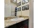 Bathroom vanity with granite countertops and decorative gaming art at 7450 Pink Moon St # 103, North Las Vegas, NV 89084