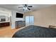 This bedroom has wood floors, ceiling fan, and a view to the en suite bathroom at 7873 Marbledoe St, Las Vegas, NV 89149
