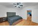 This bedroom has wood floors, ceiling fan, and is brightly lit at 7873 Marbledoe St, Las Vegas, NV 89149