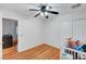 Bright bedroom features wood floors, ceiling fan and closet at 7873 Marbledoe St, Las Vegas, NV 89149