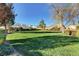Expansive community green space with lush grass, mature trees, and manicured landscaping at 7873 Marbledoe St, Las Vegas, NV 89149