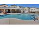 Sparkling community pool area with lounge chairs, covered seating, and well-maintained surroundings at 7873 Marbledoe St, Las Vegas, NV 89149