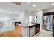 An open-concept kitchen with a center island, stainless steel appliances, and modern finishes at 7873 Marbledoe St, Las Vegas, NV 89149