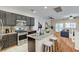A kitchen featuring an island with seating, stainless steel appliances, and an open concept layout at 7873 Marbledoe St, Las Vegas, NV 89149