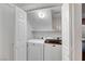 Laundry room features washer, dryer, shelf and overhead light at 7873 Marbledoe St, Las Vegas, NV 89149