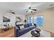 Well-lit living room featuring hardwood floors, comfortable seating, and large windows for natural light at 7873 Marbledoe St, Las Vegas, NV 89149