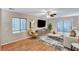 Cozy living room featuring hardwood floors, contemporary furniture, and sliding glass doors to the outside at 7873 Marbledoe St, Las Vegas, NV 89149