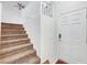 Inviting foyer with a carpeted staircase leading to the upper level of the home at 7873 Marbledoe St, Las Vegas, NV 89149